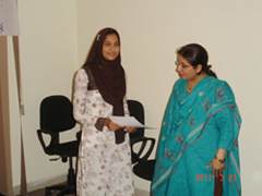 Ms. Sidra awarding certificate to Miss. Wirda