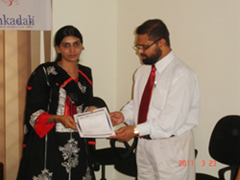 Dr. Shahnawaz awarding certificate to Miss. Humaira Q.
