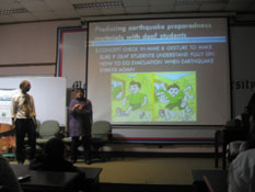 photo: Galuh giving presentation on safe evacuation